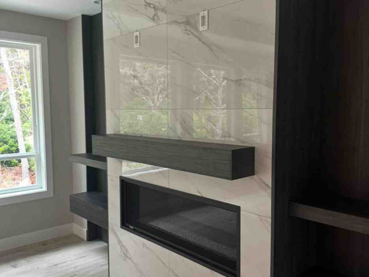 Living room fireplace remodeling project by One Construction LLC